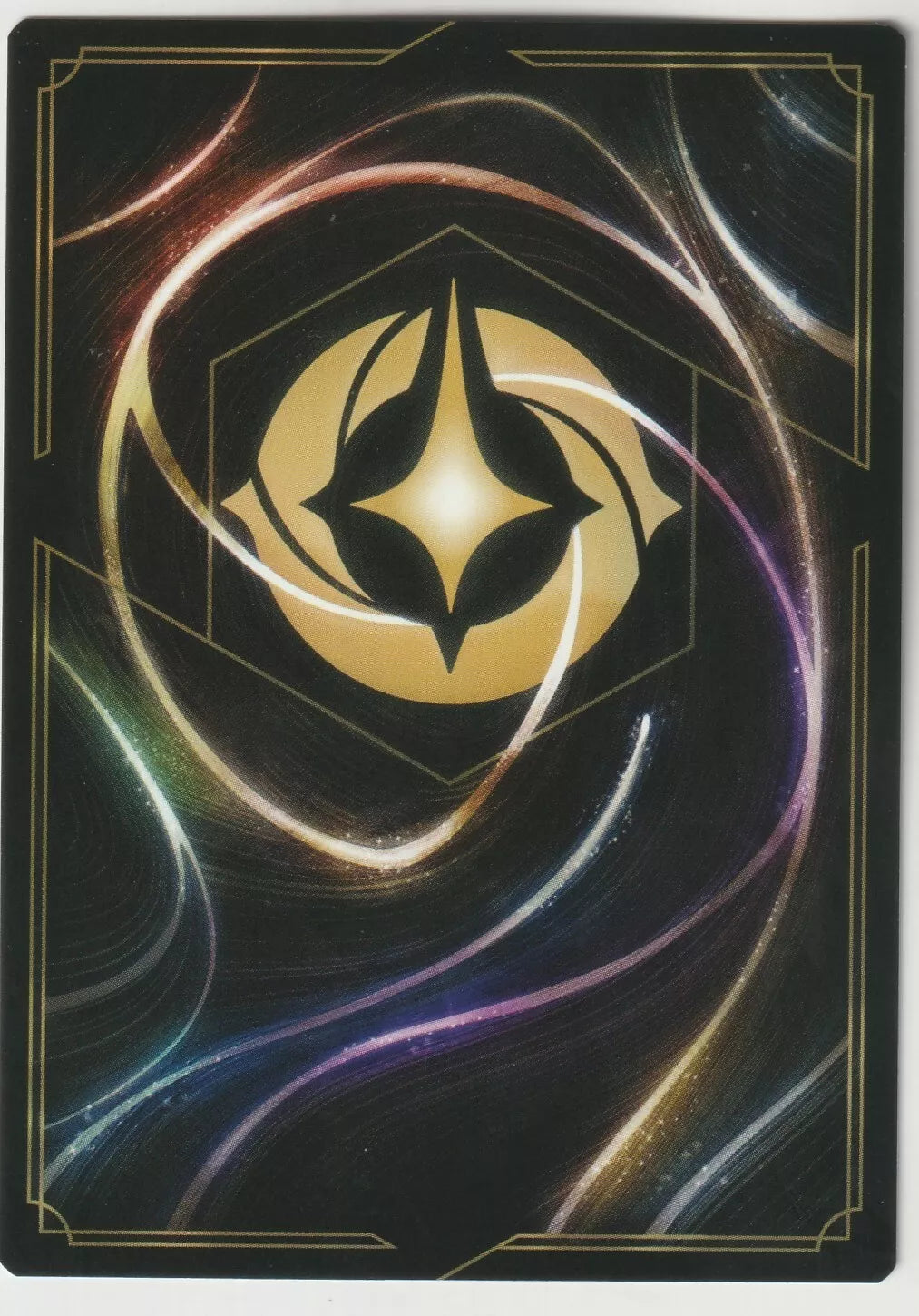 The reverse side of a Disney Lorcana card, displaying the iconic gold Lorcana symbol with colorful swirling patterns.