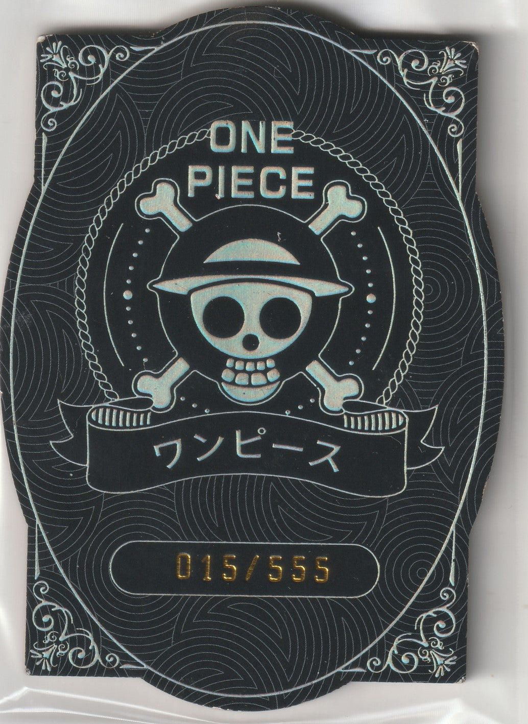 One Piece limited edition collectible card back featuring Jolly Roger logo with serial number 015/555.