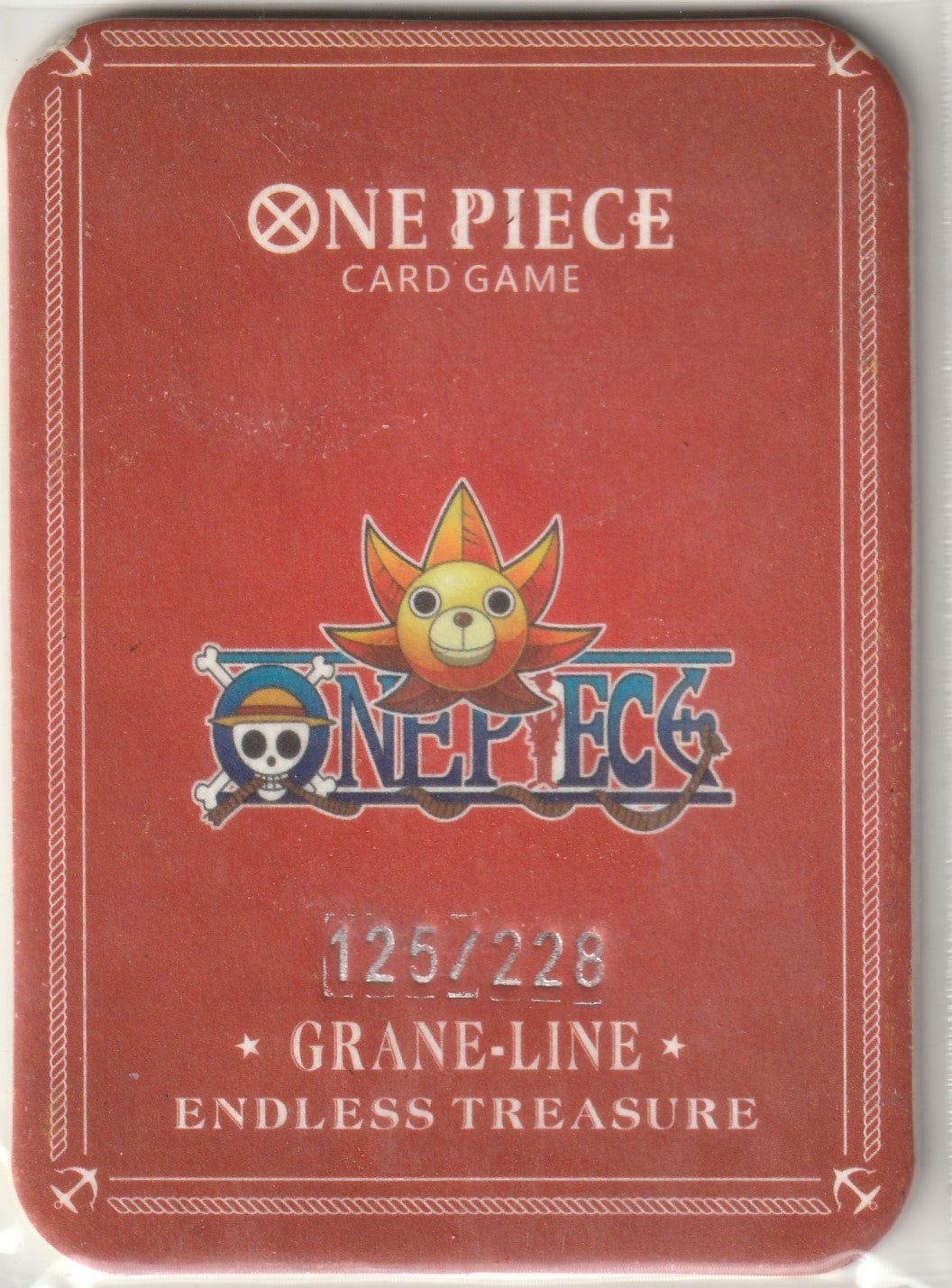 Back of One Piece collectible card with Thousand Sunny logo, red background, and limited edition serial number 125/228.