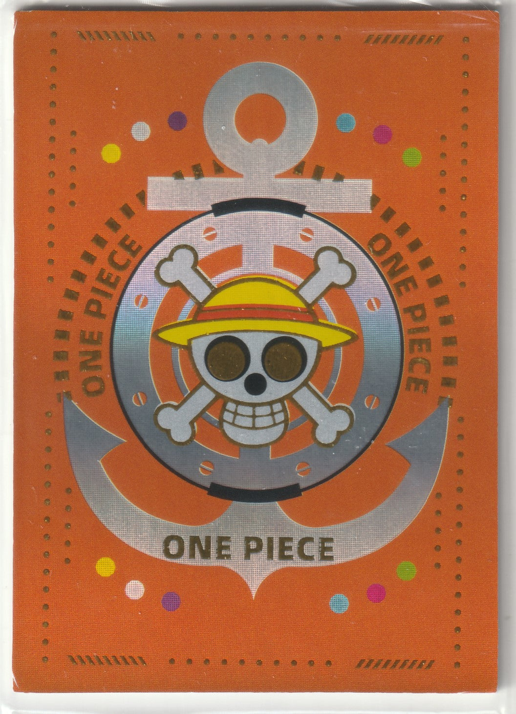 "One Piece Jolly Roger logo with a silver anchor design on a bright orange background with decorative dots and colorful confetti accents."