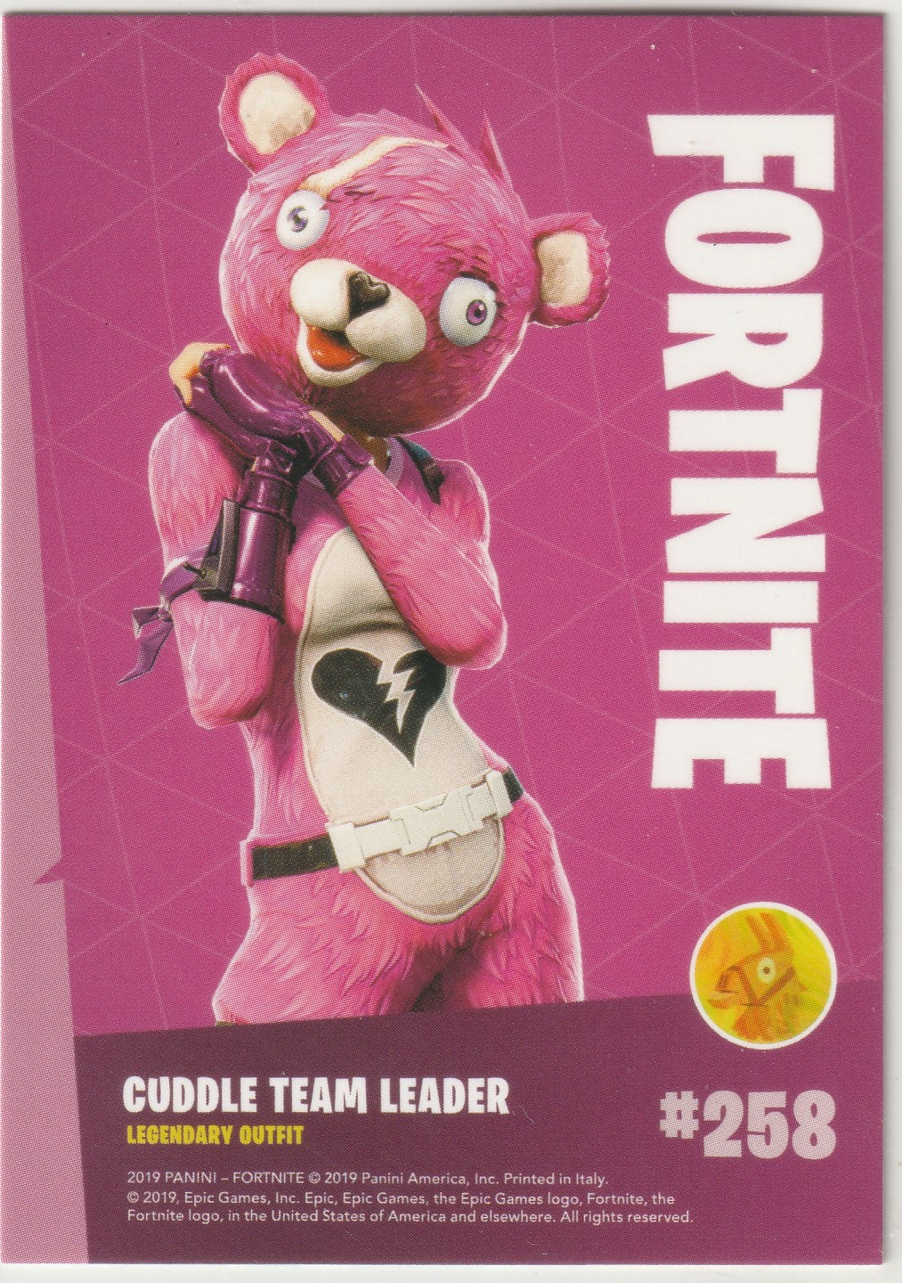 "Exclusive Fortnite trading card featuring the legendary Cuddle Team Leader outfit (#258). Showcasing the cute and teddy bear-inspired design of this iconic character with large purple eyes and a friendly smile. Official Epic Games x Panini collectible from the 2019 Series 1 ."