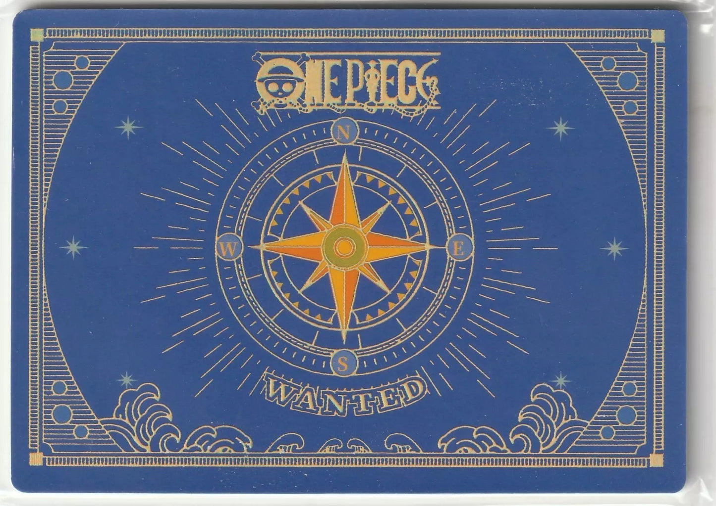 "Golden compass design on a navy blue background with 'One Piece' and 'WANTED' text, resembling a treasure map or nautical theme."