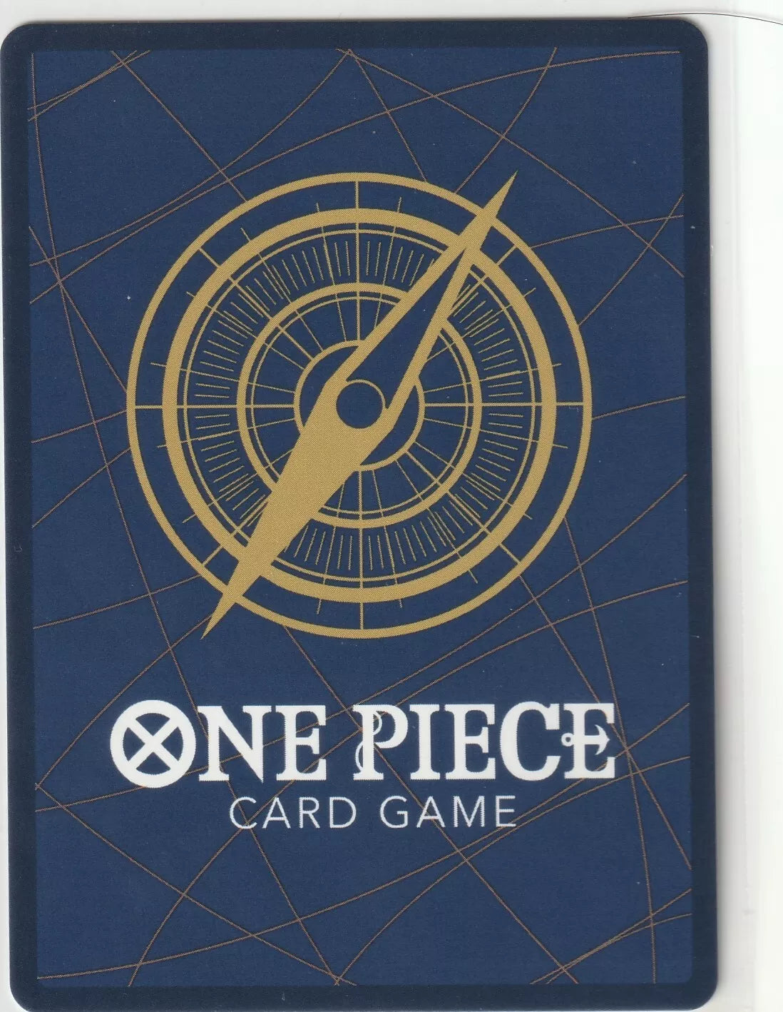 The back of a One Piece TCG card featuring a blue background, a golden compass, and the One Piece Card Game logo.