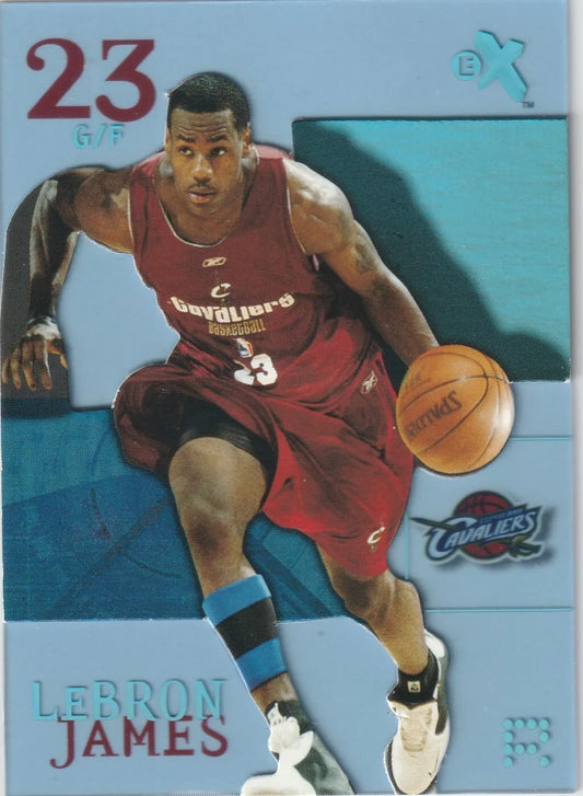 LeBron James dribbling a basketball in a Cleveland Cavaliers jersey on the front of a 2003-04 Fleer E-X Essentials Credentials Now #102 card."