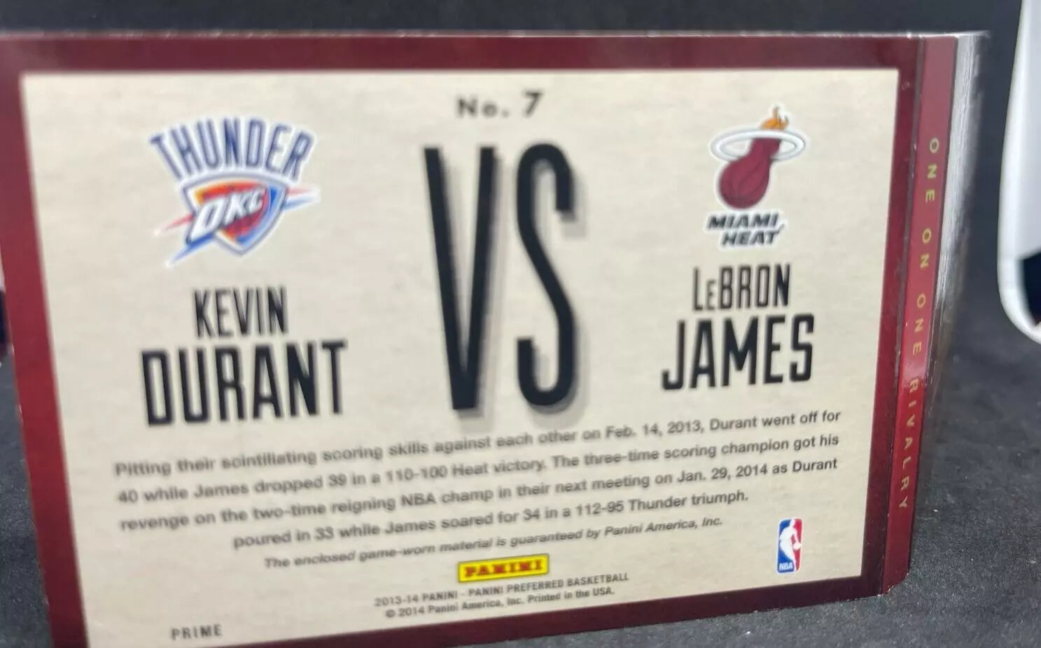 "Back of the 2013-14 Panini Preferred Dual Patch LeBron James vs Kevin Durant Game-Worn card, detailing two key matchups between the players, with team logos and Panini branding."