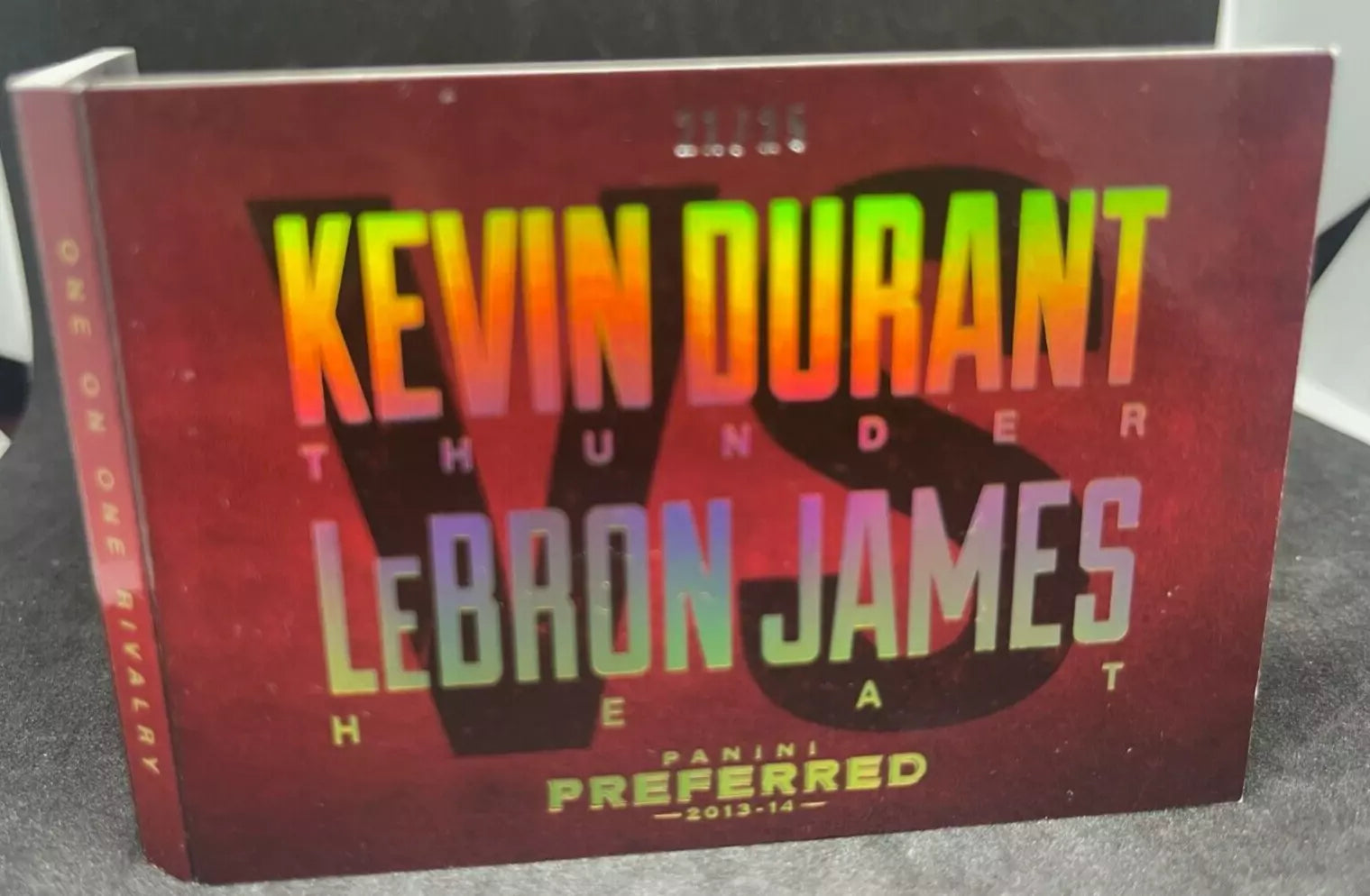  "2013-14 Panini Preferred Dual Patch LeBron James vs Kevin Durant Game-Worn card, featuring holographic lettering with team logos and numbered 21/25."