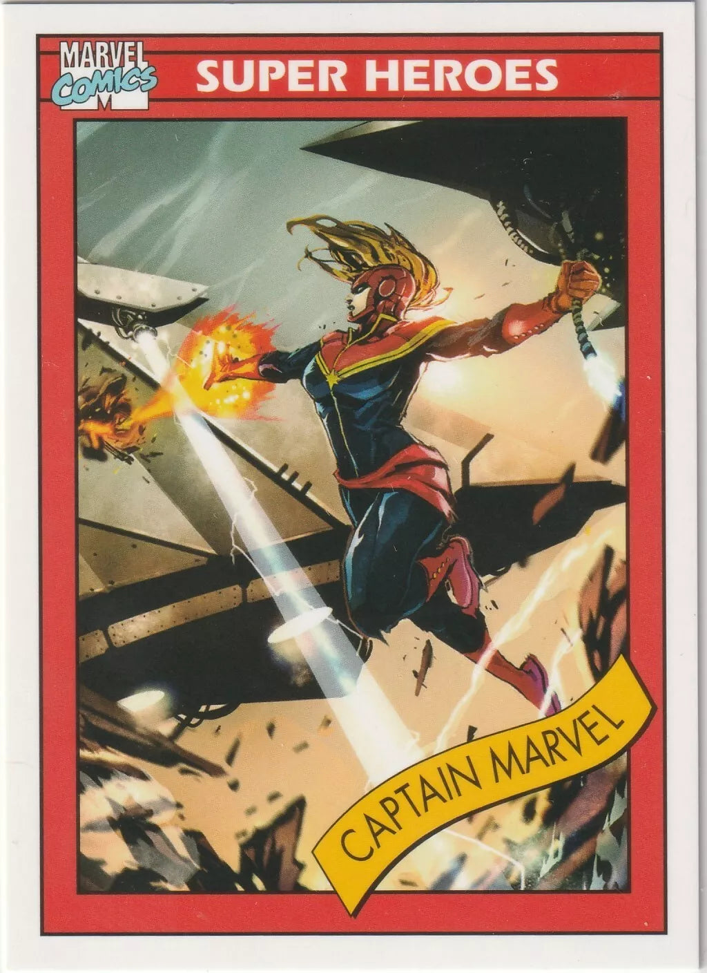 Captain Marvel flying through a battle scene with energy beams emitting from her hands in her red and blue suit, with her golden hair flowing behind her.