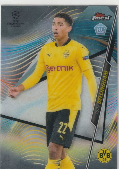 Jude Bellingham in Borussia Dortmund yellow kit, Topps Finest rookie card design, featuring UEFA Champions League and RC badge.
