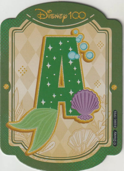 Disney 100 Alphabet Sticker featuring the letter 'A' for Ariel from The Little Mermaid. The design includes green and gold colors, seashell and bubble details, and a sparkling mermaid tail.