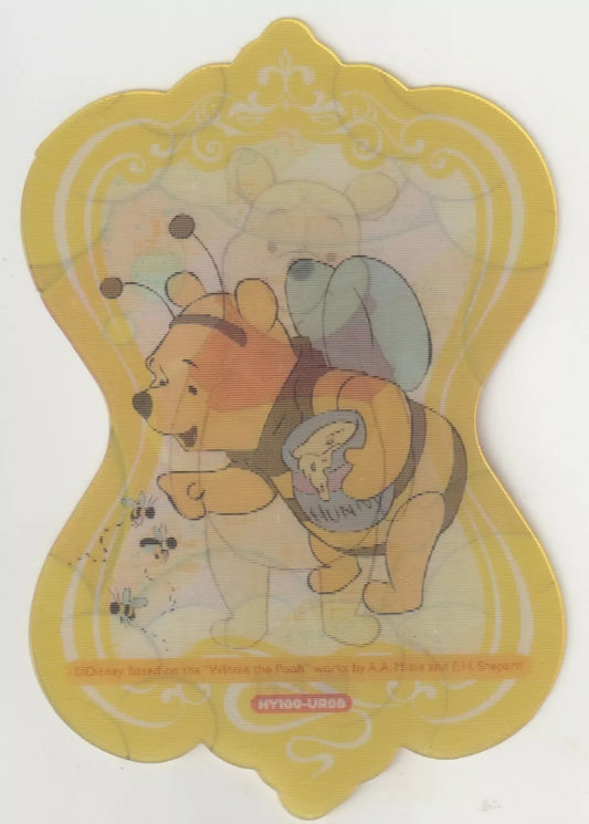 Winnie the Pooh dressed as a bee, holding a pot of honey, with a decorative yellow die-cut border