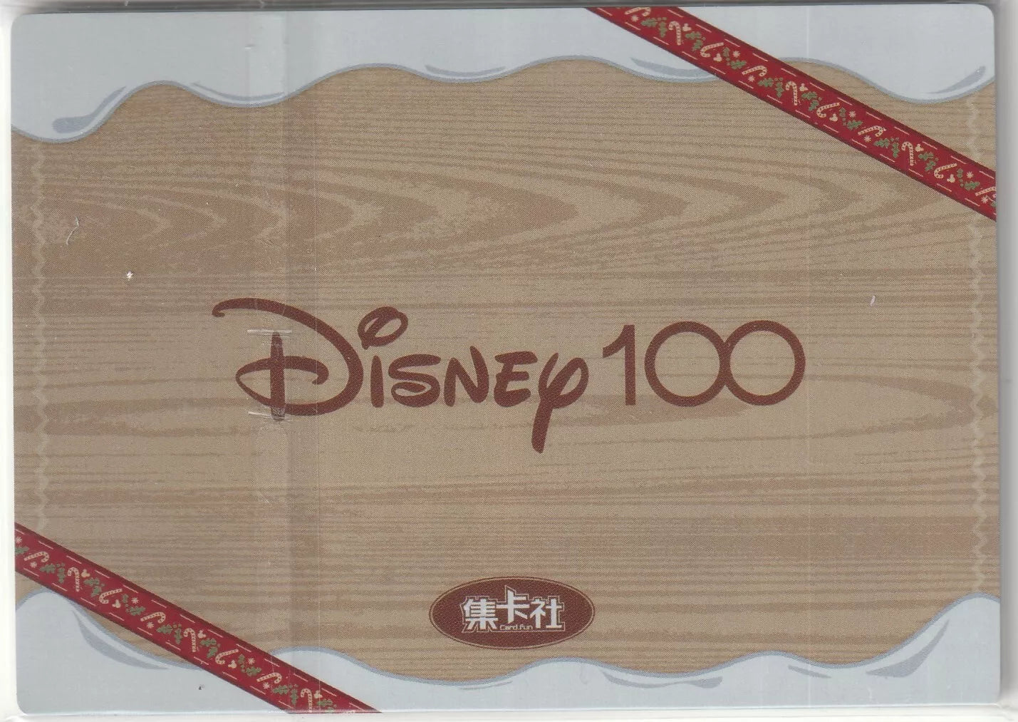 Wooden pattern background with a red ribbon design and the Disney 100 logo in the center.