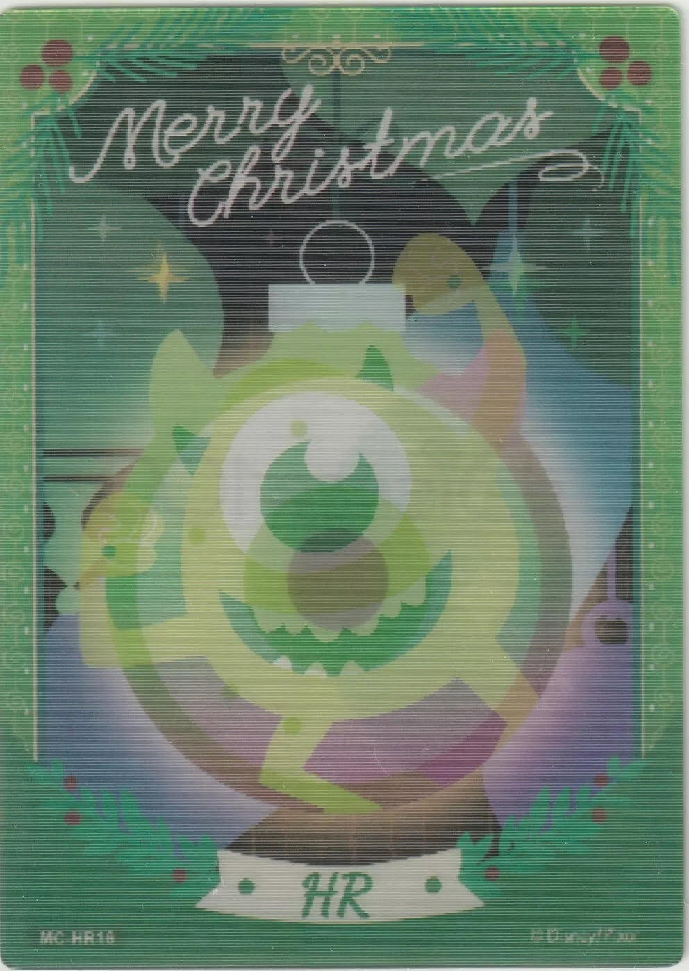 Lenticular card showing Mike Wazowski inside a green Christmas ornament, surrounded by festive decorations and "Merry Christmas" text.