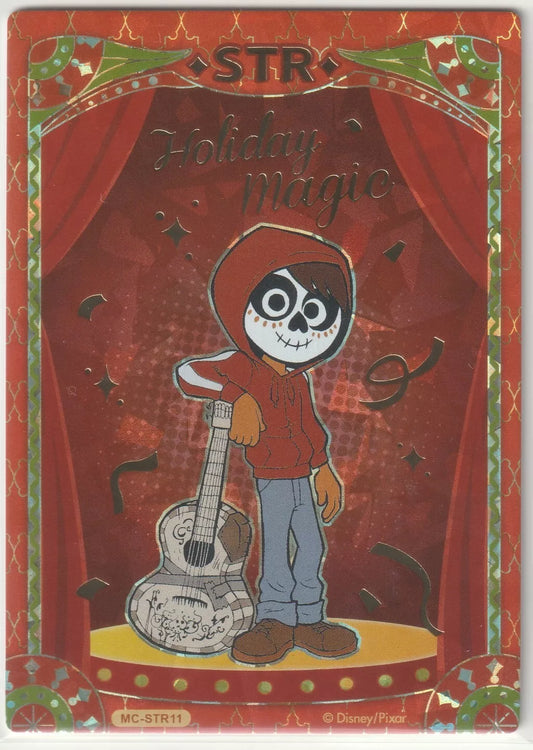 Miguel from Coco with his guitar on a Disney 100 holiday-themed red and gold background.