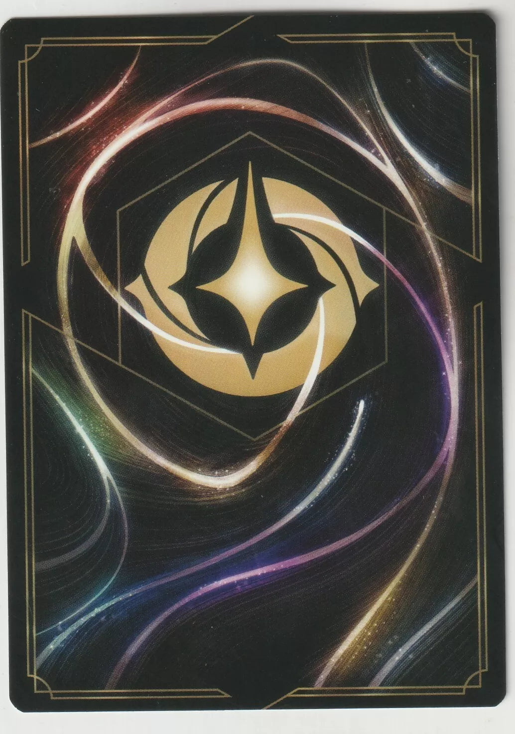 Disney Lorcana card back with a golden emblem and swirling light in cosmic colors on a black background.