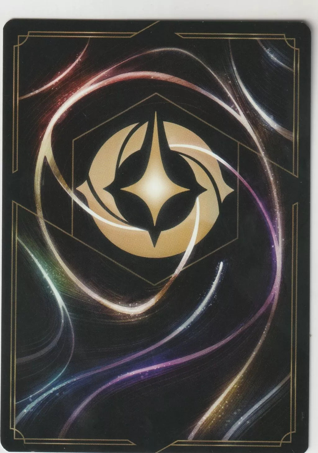 The back of a Disney Lorcana The First Chapter card, featuring swirling magical designs and the Lorcana symbol in the center.