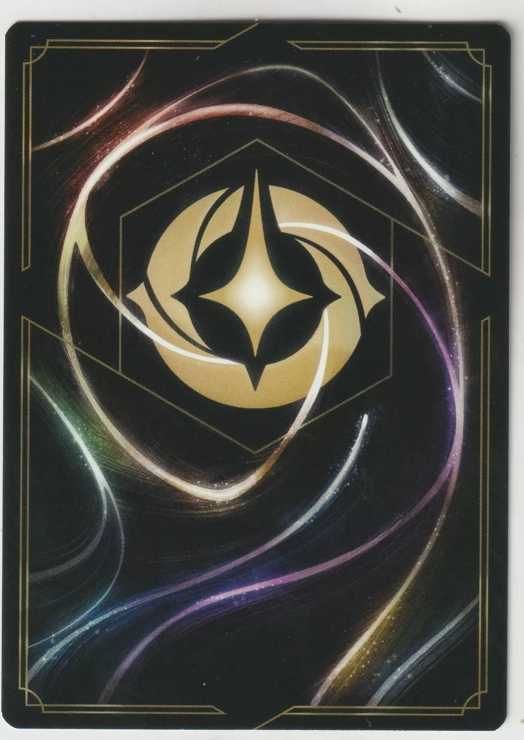 The back of a Disney Lorcana The First Chapter card, featuring swirling magical designs and the golden Lorcana symbol in the center