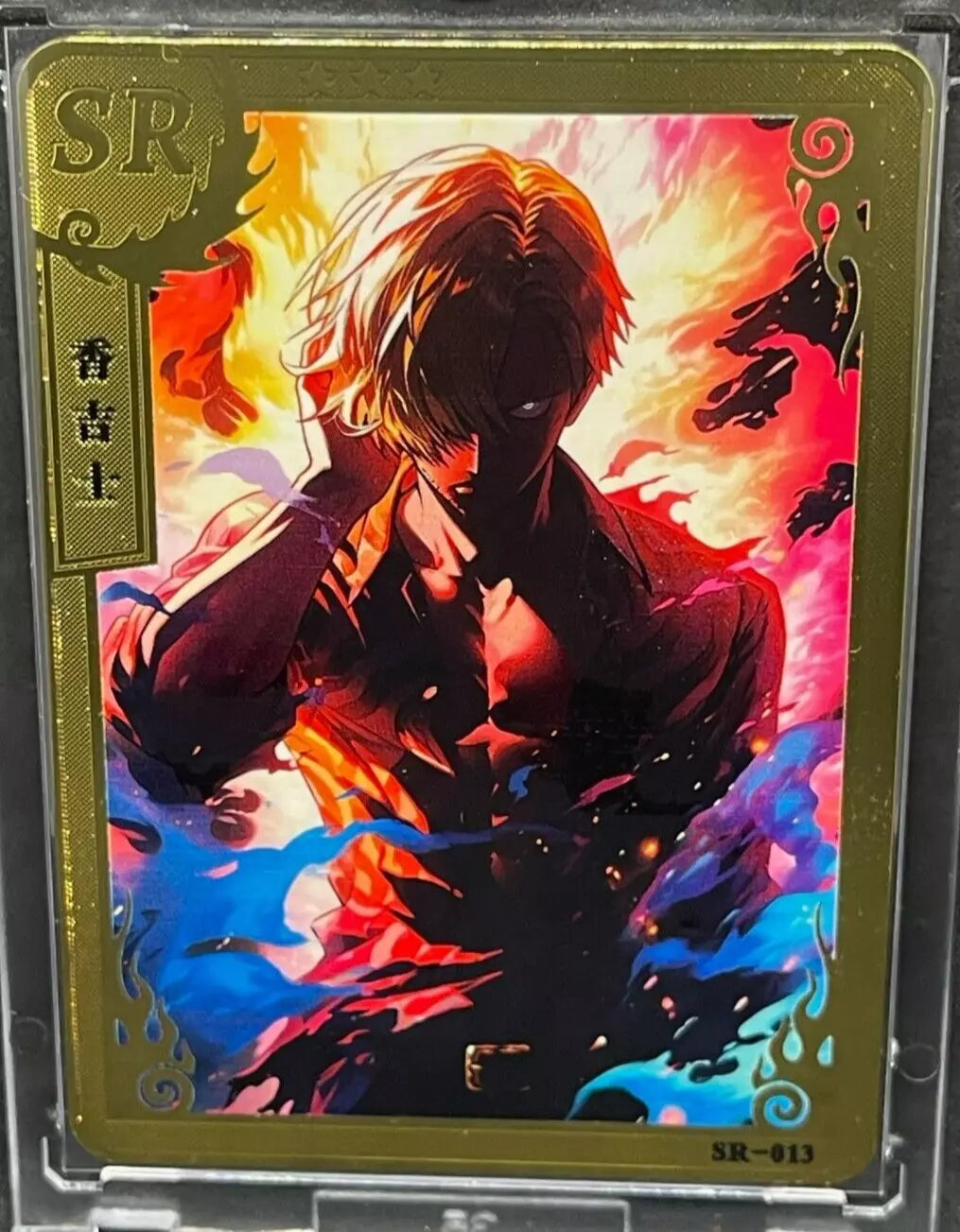 Gold metal Sanji Vinsmoke SR-013 One Piece Super Rare card front view with fiery background and vivid artwork.