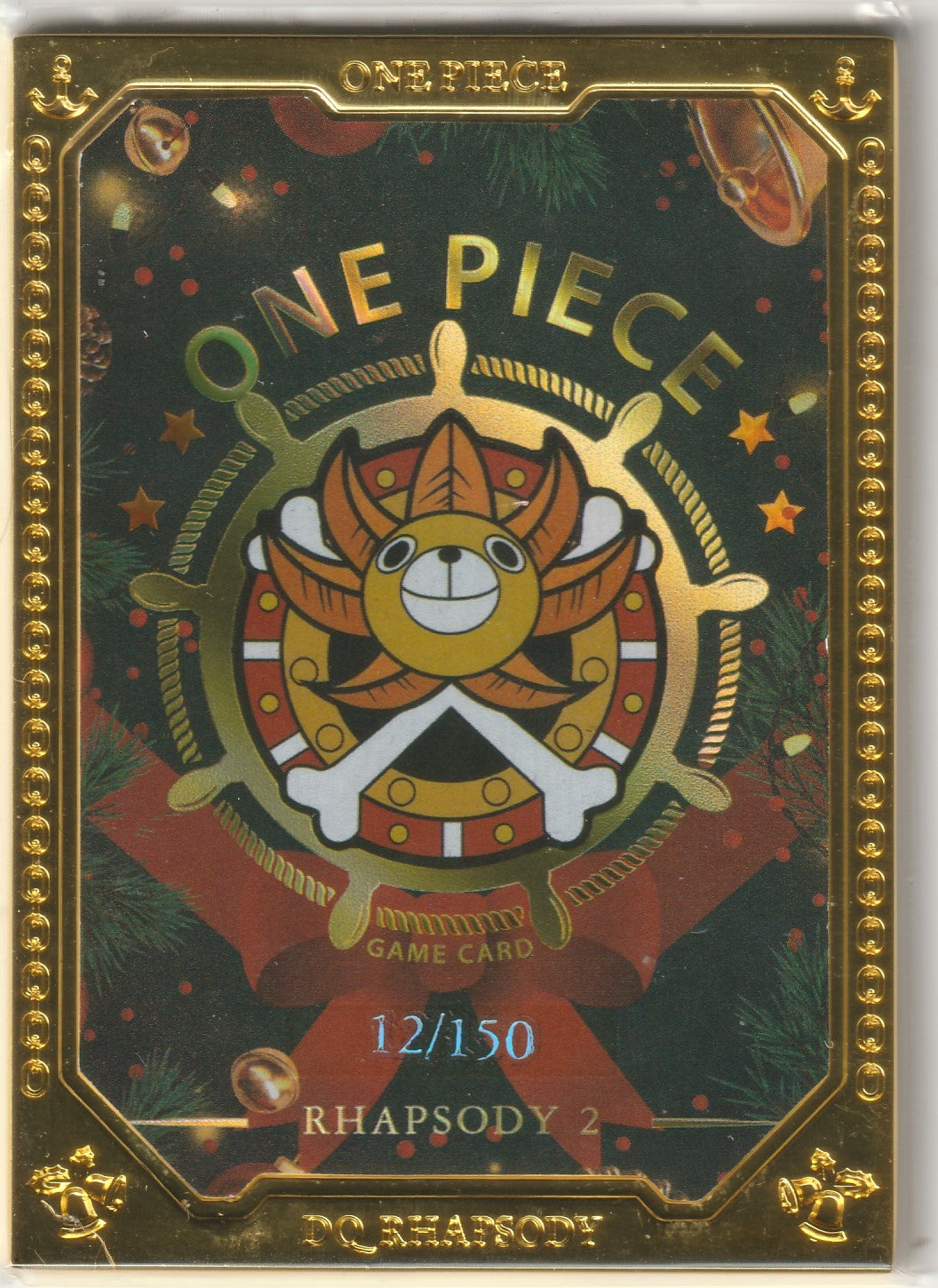 Back of a collectible One Piece card showcasing the Thousand Sunny emblem with a festive design and gold frame, marked as 12/150 from the Rhapsody 2 series.