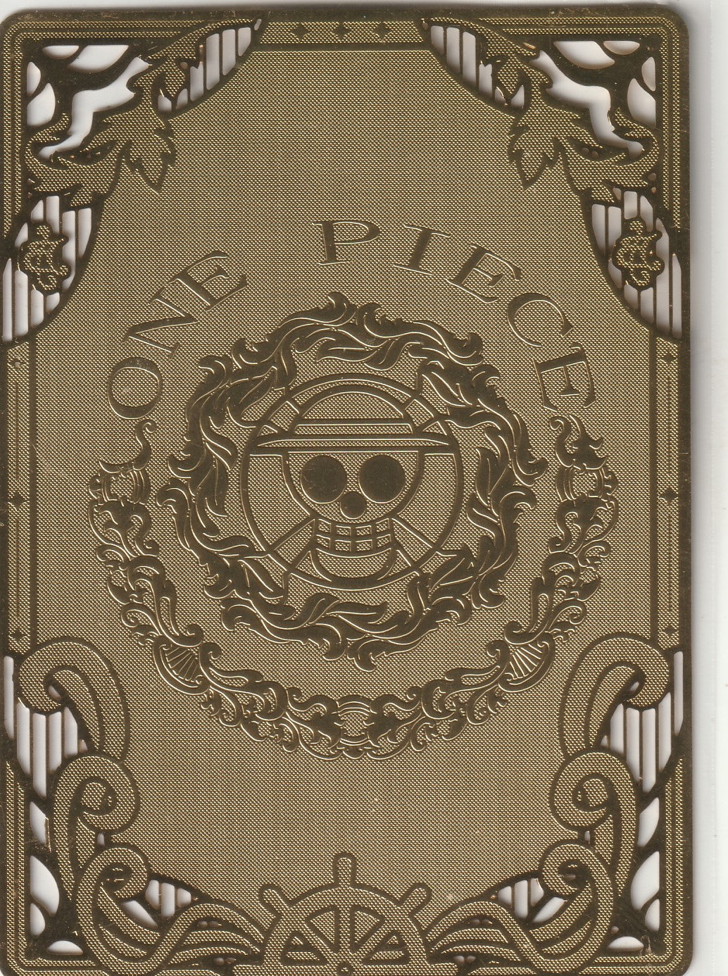 Back of a collectible card showcasing a luxurious gold-etched design with the One Piece logo and detailed ornamental patterns.