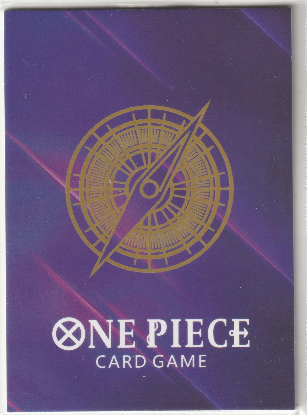 Golden compass design on a dark purple background with 'One Piece Card Game' text below.