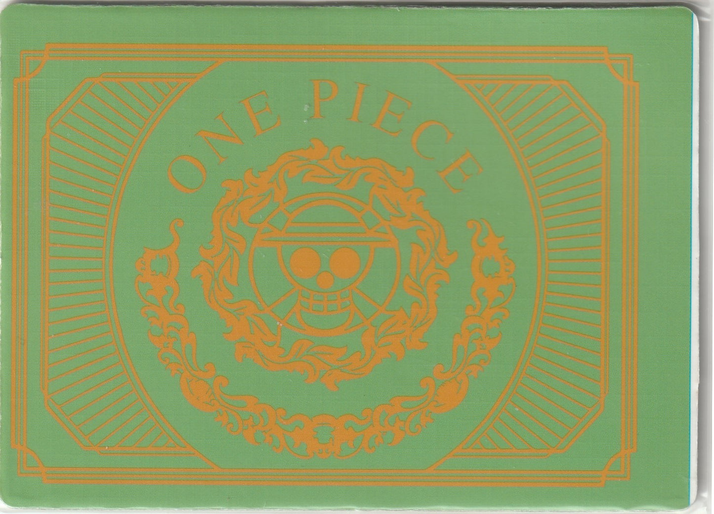 Back of One Piece card displaying gold Straw Hat Jolly Roger emblem with ornate patterns and 'ONE PIECE' text on a green background.