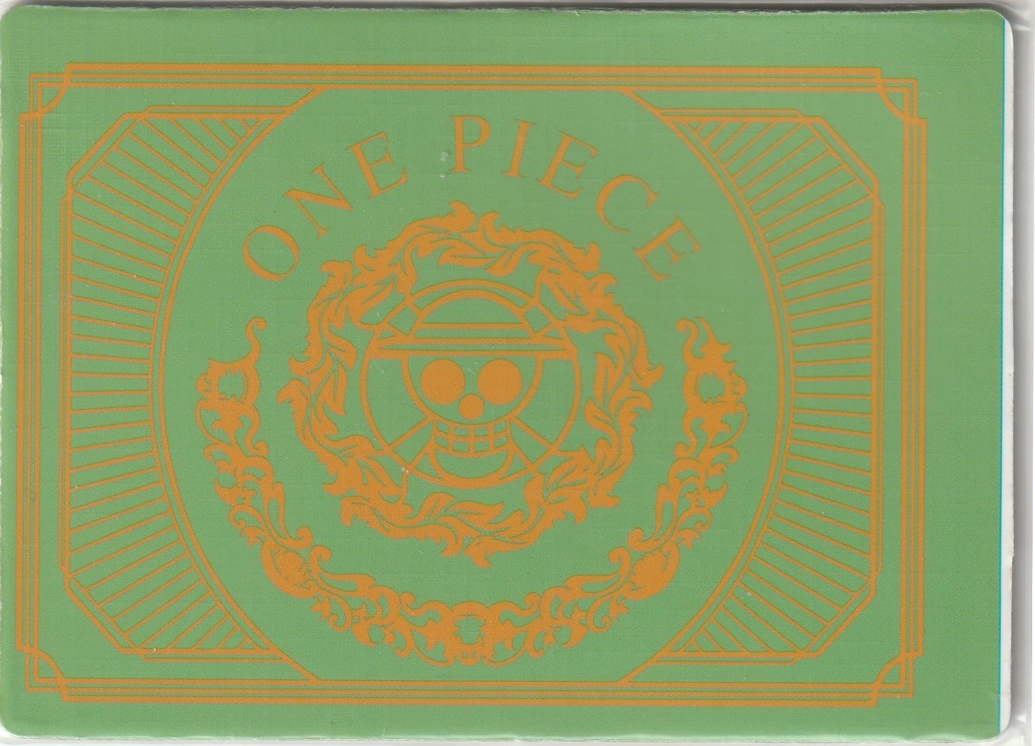 Back of One Piece card displaying gold Straw Hat Jolly Roger emblem with ornate patterns and 'ONE PIECE' text on a green background.