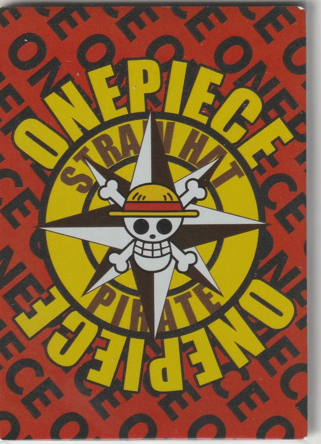 The back of an anime card featuring the Straw Hat Pirates' Jolly Roger symbol against a bold red and yellow background with "One Piece" text in a dynamic pattern.