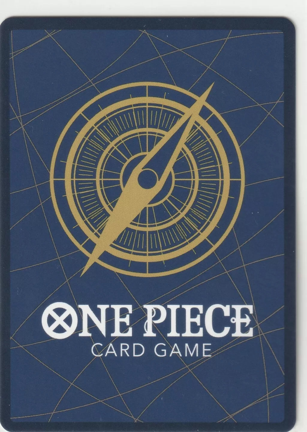 The back of a One Piece TCG card with a blue background, a golden compass motif, and the One Piece Card Game logo.