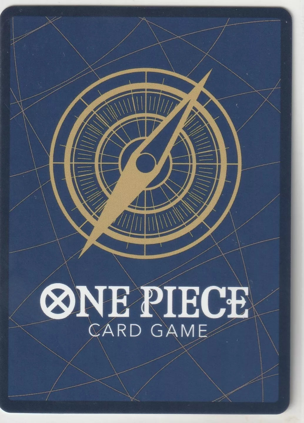 "One Piece Card Game back design featuring a golden compass on a navy blue background with subtle gold lines."