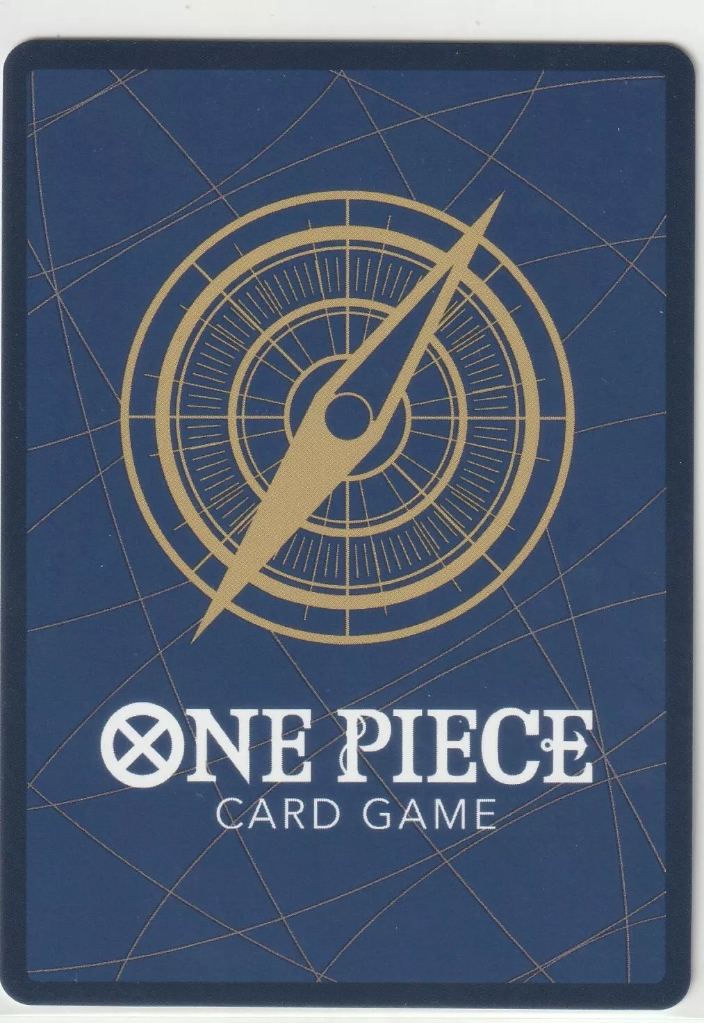 "Back of a One Piece TCG card featuring a golden compass design on a dark blue background."