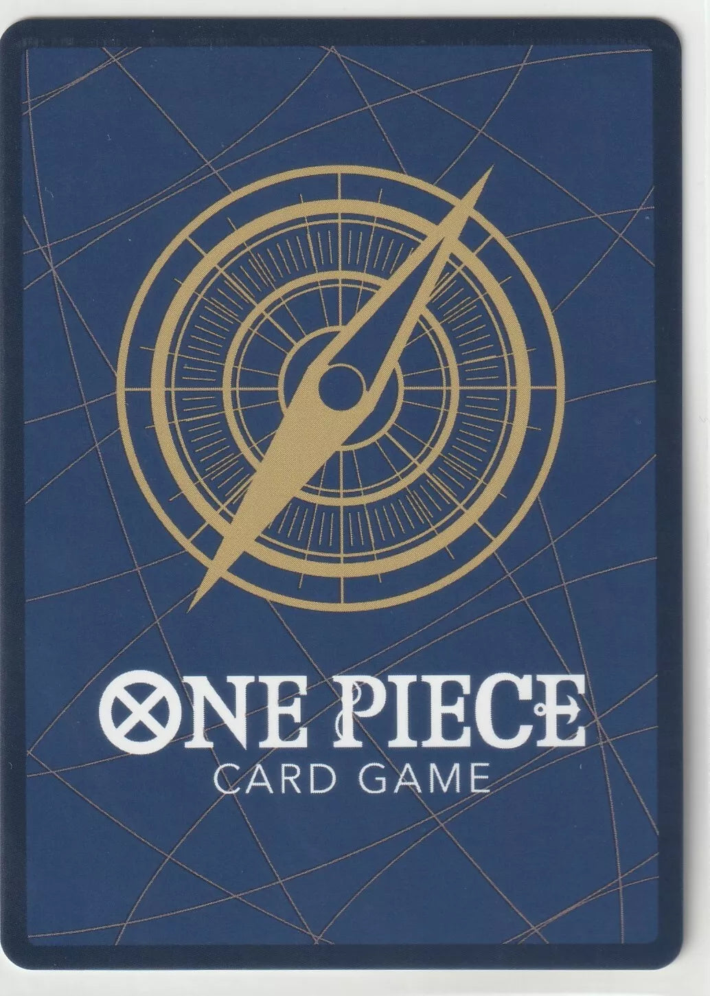 "Back of a One Piece TCG card featuring a golden compass design on a deep blue background."