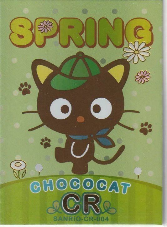 Chococat from Sanrio with a green cap and scarf, in a spring-themed setting with flowers and paw prints, finished with foil accents.