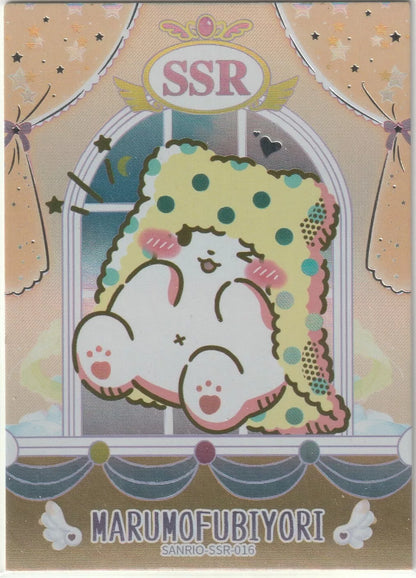 Sanrio SSR-016 Marumofubiyori foil character card featuring a cozy, blanket-wrapped character with a soft pastel background and sparkling accents.