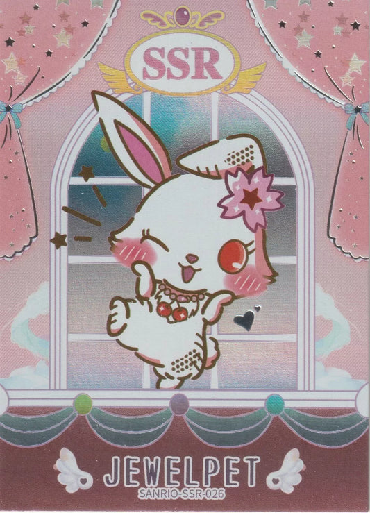 "Jewelpet character on the front of the Sanrio SSR-026 foil card, wearing a flower on her ear and a cherry necklace, in front of a pastel pink curtain background."

