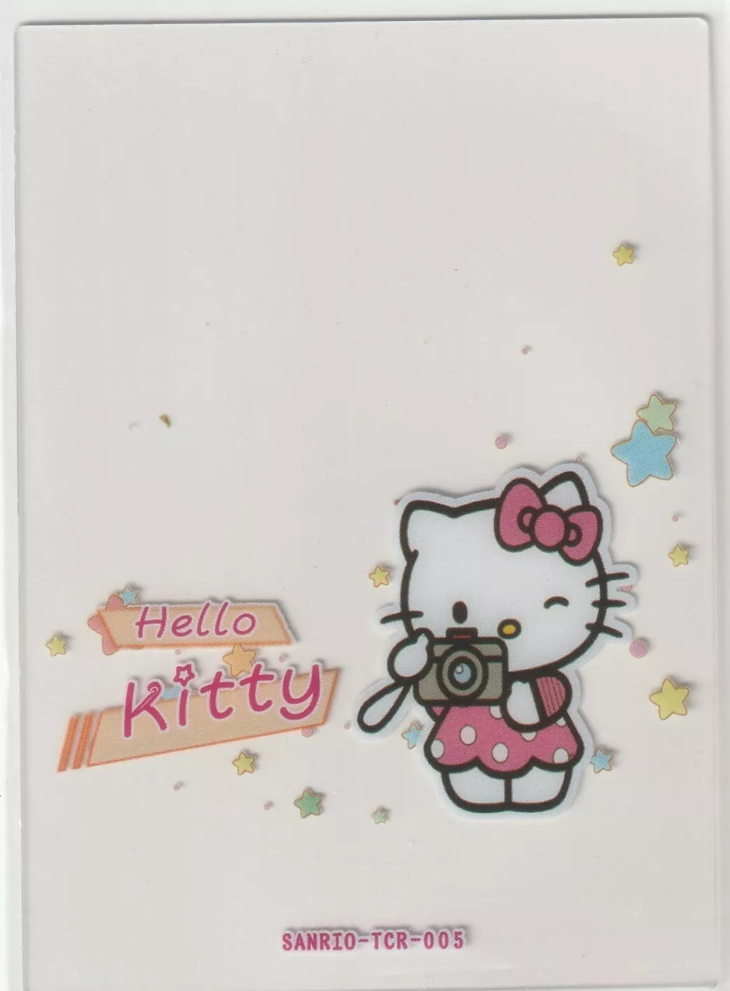 Hello Kitty collectible card front featuring Hello Kitty holding a camera, surrounded by pastel stars, and 'Hello Kitty' written in soft pink on a transparent background.